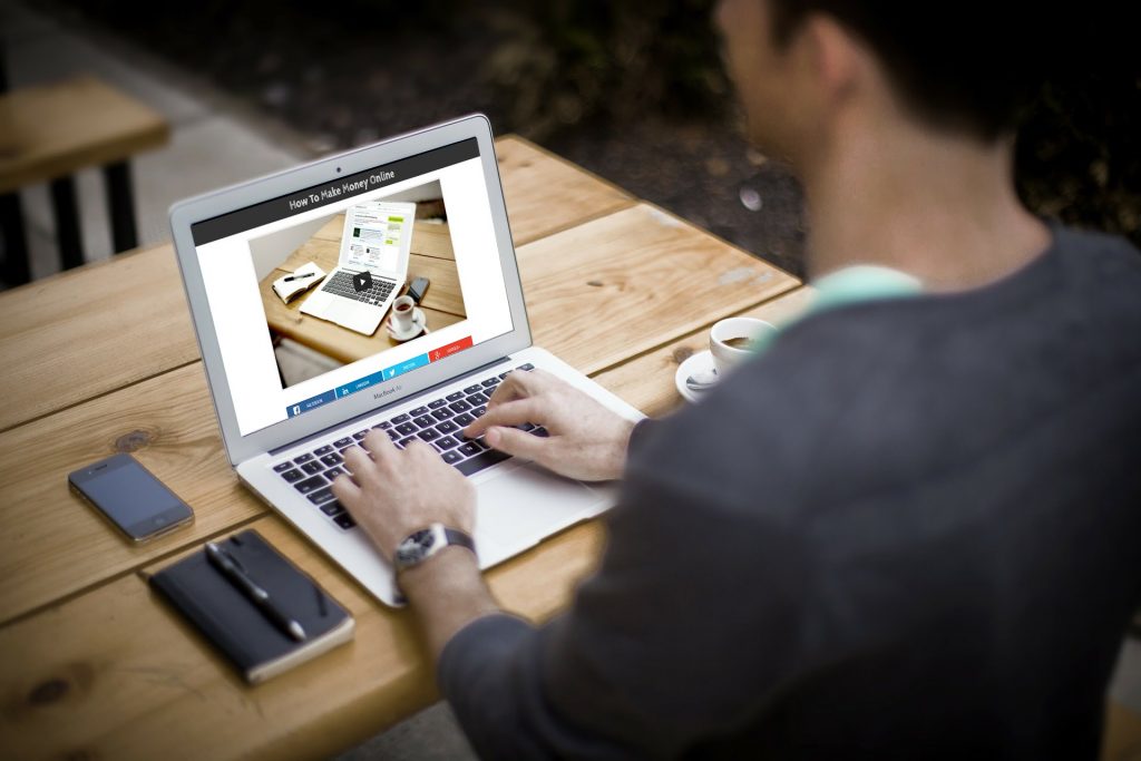 Man Sitting at PC Searching How To Make Money Online