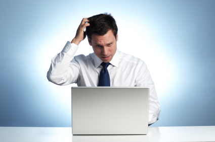 Man Scratching Head at Computer